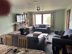 sala de estar con 2 sofás y chimenea en Seaview en Glenelg