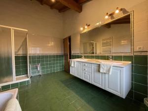 a bathroom with two sinks and a large mirror at Aikobeko in Sare +29 photos