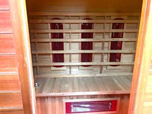 an empty shelf in a wooden door with red curtains at Jungle style lodge with jacuzzi ,sauna and garden near Amsterdam in Vijfhuizen