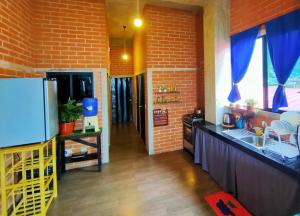 a kitchen with a brick wall and a refrigerator at 100m2 Front Beach private apartment in Puerto López