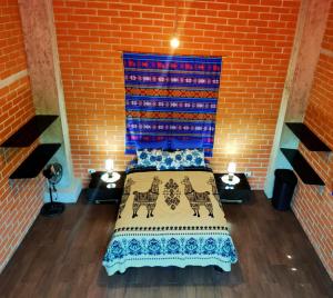a bedroom with a bed in a brick wall at 100m2 Front Beach private apartment in Puerto López