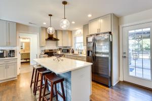 a kitchen with a refrigerator and a counter top at Wilmington Home with Gazebo Deck 4 Mi to Beach! in Wilmington