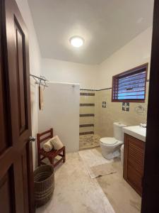 a bathroom with a toilet and a sink at Casa Tom Tom in Holbox Island