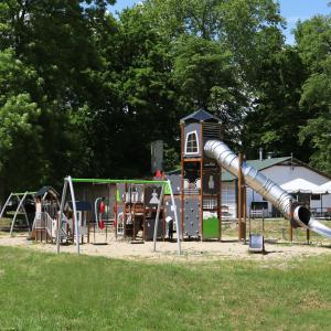 a playground with a slide in a park at Pałac w Kurozwękach in Kurozwęki