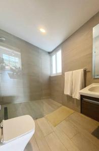 a bathroom with a toilet and a sink at Beautiful Penthouse with private elevator in Hard Rock Golf in Punta Cana