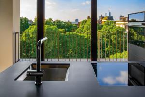 a kitchen sink in front of a balcony with a view at Bulgari Hotel Milano in Milan