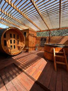 a large wooden deck with a wooden pergola at El Encanto del Manzano & Espacio Vittalia Spa in San José de Maipo