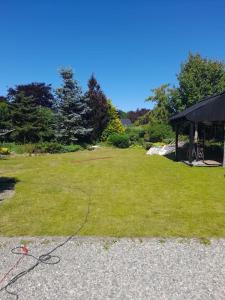 a large grassy yard with a gazebo at Flat in the heart of Billund, 600m to Lego House, close to Legoland, Lalandia, Airport, in Billund
