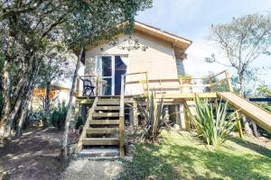 a house with a staircase leading up to it at O Chalé Encantado - Rancho Queimado in Rancho Queimado