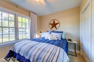 a bedroom with a blue bed and a window at Idyllic and Central New Bern Home with Screened Porch! in New Bern