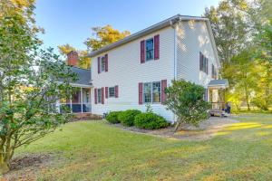 a white house with red windows and a yard at Idyllic and Central New Bern Home with Screened Porch! in New Bern