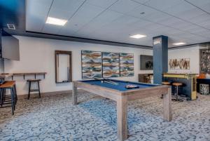a room with a pool table in the middle of it at Village at Breckenridge Resort in Breckenridge