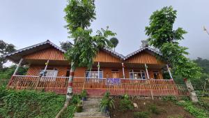 a house on the side of a hill at Kolakham Hillcrest Homestay in Rishop