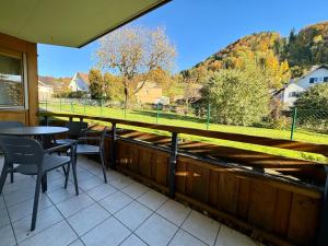 a balcony with a table and chairs and a view at Bauernchalet Alois in Dornbirn