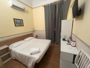 a small room with a bed and a television at Conte House merulana guesthouse in Rome