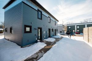 a house in the snow with a garage at Stella Boona Loft Traverse close to Trail and beach in Traverse City