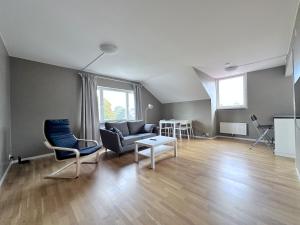 a living room with a couch and chairs and a table at AD Long Stay Apartments in Stockholm +1 photo