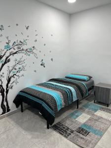 a bedroom with two beds with birds on the wall at Zimmer Türkis mit Weitblick und Sauna in Sundern