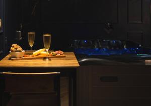 a table with two glasses of champagne and a plate of food at Le Refuge Bleu in Famars +8 photos