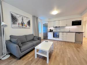 a living room with a couch and a table at AD Long Stay Apartments in Stockholm
