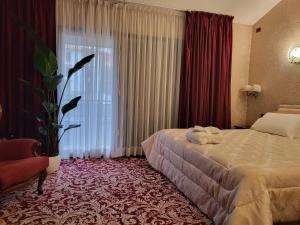 a hotel room with a bed and a large window at GRAND HOTEL LE FONTI in Chianciano Terme
