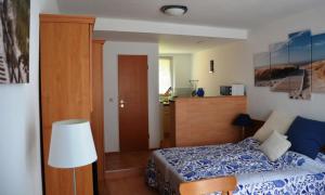 ティースゾーにあるStrandapartment-Mondfisch an der Ostseeのベッドルーム1室(ベッド1台付)、キッチンが備わるアパートメントです。
