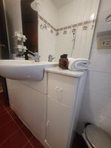 a white bathroom with a sink and a toilet at GRAND HOTEL LE FONTI in Chianciano Terme +15 photos