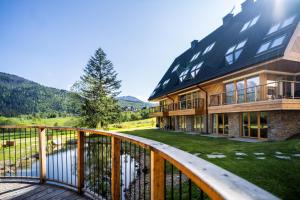a large house with a deck with a view at Apartament Magiczne Podhale by Apart Concept Podhale in Kościelisko