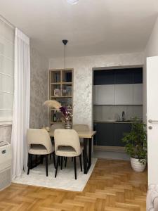 a kitchen and dining room with a table and chairs at Monarh in Bijeljina