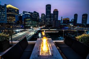 a view of a city skyline at night at The Envoy Hotel, Autograph Collection in Boston