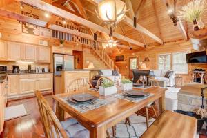 a dining room and kitchen with a table and chairs at LUX 4BD Lodge w/ Views! Fire Pits + HOT TUB + Pool in Gatlinburg
