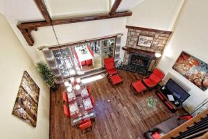 an overhead view of a living room with red chairs and a fireplace at Manoir B - Mont-Tremblant in Mont-Tremblant