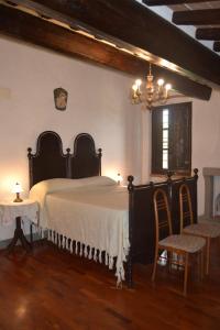 Säng eller sängar i ett rum på Cortona Gabolina e Turata Holiday Home
