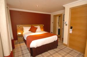 a bedroom with a large bed in a room at The Inn on Loch Lomond in Luss