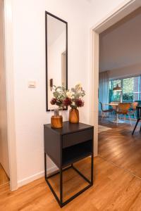 a black table with a mirror on top of it at Wohnung mit Tiefgarage u. Balkon in Paderborn