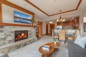 a living room with a fireplace and a dining room at Luxury Condo in the Village at Northstar in Truckee