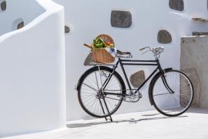 a bike with a basket in a room at Colours of Mykonos Luxury Residences & Suites in Psarou