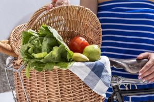 a basket filled with fruits and vegetables on a bike at Colours of Mykonos Luxury Residences & Suites in Psarou