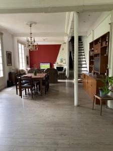 a large living room with a table and chairs at Edificio Quijano in Montevideo