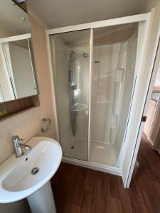 a bathroom with a shower and a sink at Bittern 13, Scratby - California Cliffs, Parkdean, sleeps 6, pet friendly, bed linen and towels included - close to the beach in Great Yarmouth