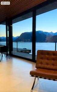 a living room with a couch and large windows at VILLA KRISTINA / ÅNDALSNES in Torvik