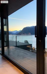 a view from the window of a house overlooking the water at VILLA KRISTINA / ÅNDALSNES in Torvik