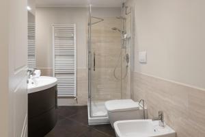 a bathroom with a shower and a toilet and a sink at Flats4Rent Federica in Verona