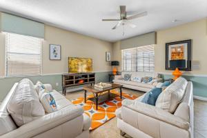 a living room with two couches and a tv at Modern 8-Bed Champions Gate Disney Magic Awaits in Davenport