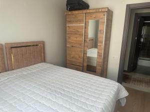 a bedroom with a bed and a dresser and a mirror at Apartment with nice View in Beylikduzu