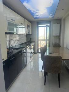 a kitchen with a wooden table and a dining room at Apartment with nice View in Beylikduzu