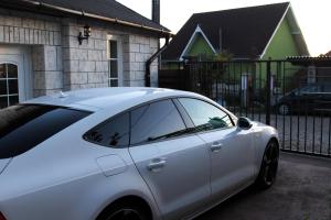 a white car parked in front of a house at Cozy Cottage - Free Parking, Self Check-in in Oradea