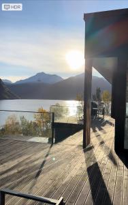 a wooden deck with a view of a lake at VILLA KRISTINA / ÅNDALSNES in Torvik