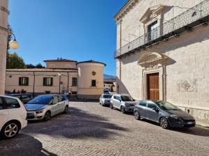 a row of parked cars parked on a street at Casa Matteo-Gran Sasso in LʼAquila