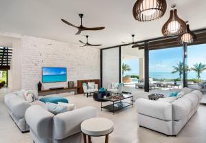 a living room with white furniture and a brick wall at Clevelander in Long Bay Hills